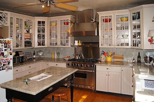 A remodeled country kitchen with gorgeous glass fronted cabinets
